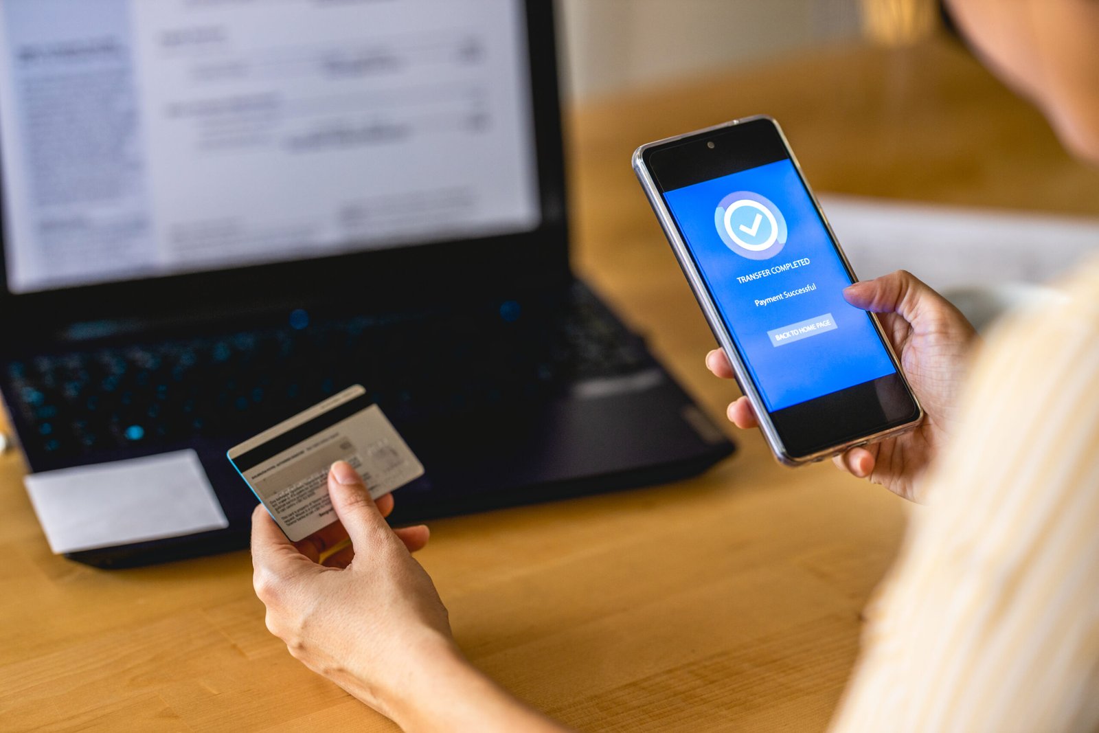 young-woman-paying-bills-with-mobile-phone-2024-11-26-11-10-45-utc